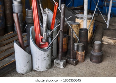 fragment of the workshop interior with different tools and parts of drilling equipment