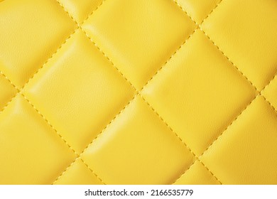 Fragment of a yellow quilted bag, close up - Powered by Shutterstock