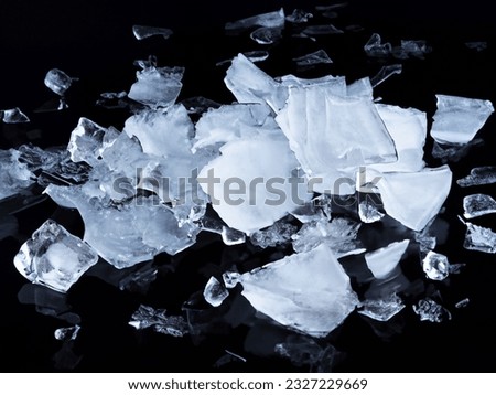 
Fragmentation of falling ice on a black background