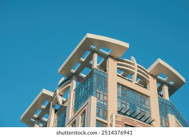 Fragments of modern buildings against the sky, capturing sleek lines, glass reflections, and bold architectural details, blending urban design with the open expanse of the horizon. - Powered by Shutterstock