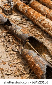 Fragments of old cast-iron water pipes. After many years of operation corroded metal pipe was destroyed. Rusty steel tube with holes of metallic corrosion. Rusty cast iron, metal - Shutterstock ID 624523136