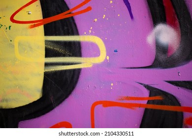Fragments of a painted wall. The wall is painted with spray paint. Concrete graffiti wall texture. - Shutterstock ID 2104330511