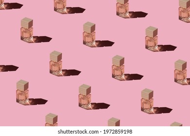 Fragnance Parfume Pattern. Miniature Bottles Of Pink Woman Perfume On A Pastel Pink Background, Top View. Mockup Of Fragrance Perfume. Trendy Sunlight Minimal Concept.

