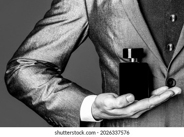 Fragrance Smell. Men Perfumes. Fashion Cologne Bottle. Man In Formal Suit, Bottle Of Perfume, Closeup. Black And White.