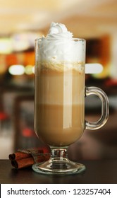 Fragrant Coffee Latte In Glass Cup With Vanilla Pods, On Table In Cafe