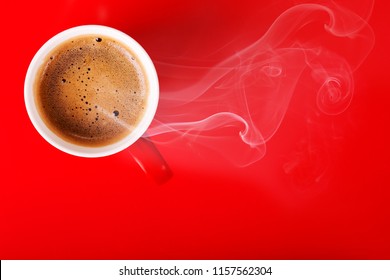 Fragrant coffee on a red background for your advertising. Smoke from hot coffee.