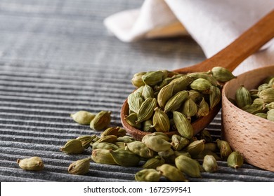 fragrant green cardamom on a wooden rustic background - Shutterstock ID 1672599541