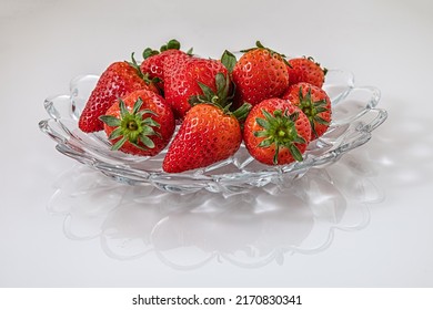 Fragrant Ripe Strawberries On A Glass Plate On White Glass Surface