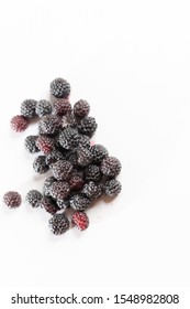 Fragrant sweet red and black raspberries on a white background.