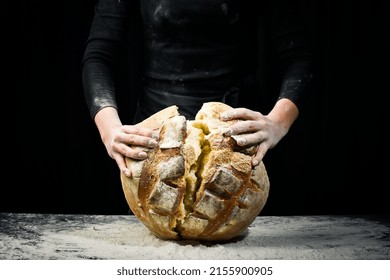 Fragrant White Baked Bread In Women's Hands. Black Flour Baking Background.