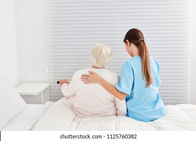 A Frail Old Elderly Woman As A Patient Gets Help Getting Out Of Bed