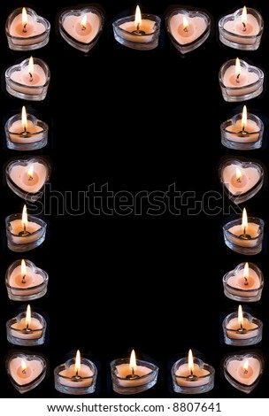 frame from burning heart-candles  on black background