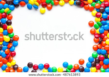 Frame of colorful candy on a white background with space for your text.