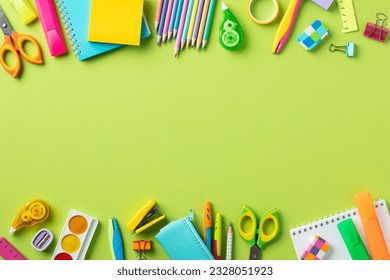 Frame of colorful school supplies on green background. Back to school concept. - Powered by Shutterstock