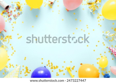 Frame of decoration birthday party on a pastel blue background with copy space top view