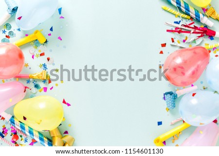 Frame of decoration party on pastel blue background top view, flat lay