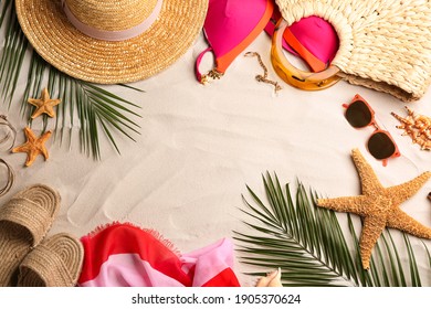 Frame Of Different Beach Accessories On Sand, Flat Lay. Space For Text