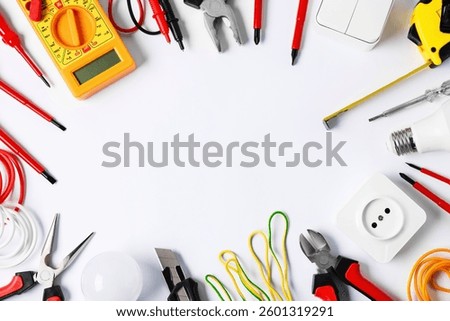 Frame of different electrical tools on light background, flat lay. Space for text