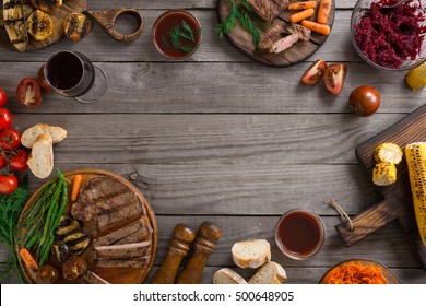 Frame Of Different Food Cooked On The Grill. Grilled Steak, Grilled Vegetables And Red Wine. Top View