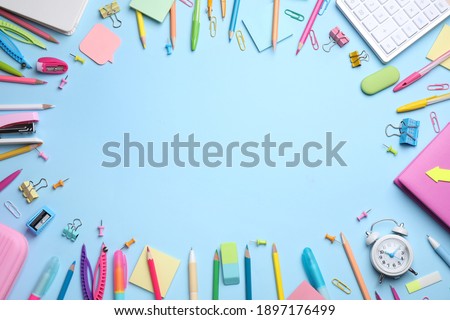 Frame of different stationery on light blue background, flat lay. Space for text