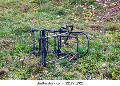 Frame from a discarded baby stroller on the grass close up