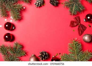 Frame Of Fir Branches And Christmas Decoration On Red Background, Flat Lay. Space For Text