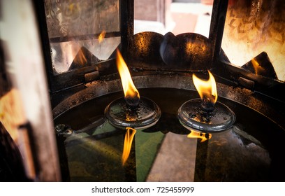 frame of fire in lamp and oil candle , Buddhist temple - Shutterstock ID 725455999