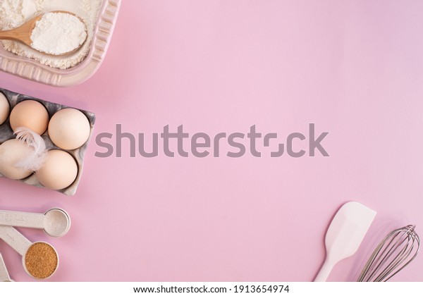 Frame of food ingredients for baking on a gently pink\
pastel background. Cooking flat lay with copy space. Top view.\
Baking concept. flat lay