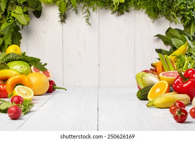 Frame With Fresh Organic Vegetables And Fruits On Wooden Background