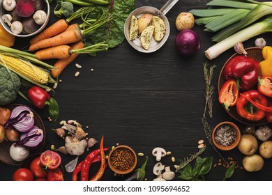 Frame of fresh organic vegetables on wood background. Healthy natural food on rustic wooden table with copy space. Carrot, pepper, leek, potato and other cooking ingredients, top view