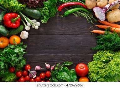 Frame Of Fresh Organic Vegetables On Wood Background. Healthy Natural Food On Rustic Wooden Table With Copy Space. Tomato, Lettuce, Carrot, Pepper, Zucchini And Other Cooking Ingredients Top View