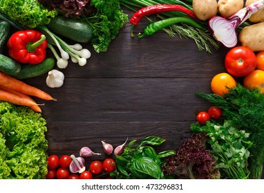 Frame Of Fresh Organic Vegetables On Wood Background. Healthy Natural Food On Rustic Wooden Table With Copy Space. Tomato, Lettuce, Carrot, Pepper, Zucchini And Other Cooking Ingredients Top View