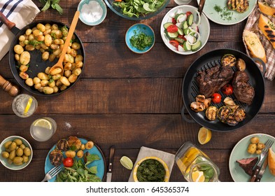 Frame Of Grilled Steak, Grilled Vegetables, Potatoes, Salad, Different Snacks And Homemade Lemonade, Top View. Concept Dinner Table