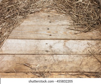 Frame of hay on rustic wooden floor with space for text