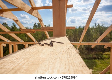 The Frame Of A House Under Construction Close Up And Screws