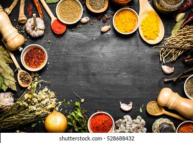 Frame of Indian spices and herbs. On the black chalkboard.