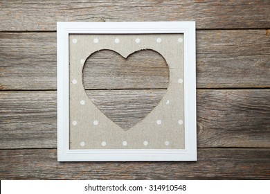 Frame with love heart  on wooden background