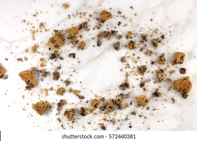 A Frame Made Up By Chocolate Chips Cookie Crumbs, Shot From Above On A White Marble Background, With A Place For Text