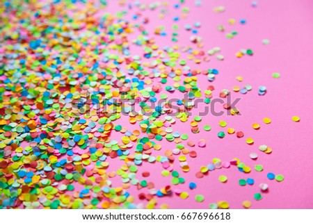Frame made of colored confetti. Pink background. 