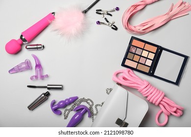 Frame made of different sex toys on light background