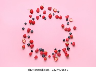 Frame made of fresh raspberries, blueberries and strawberries on pink background - Powered by Shutterstock