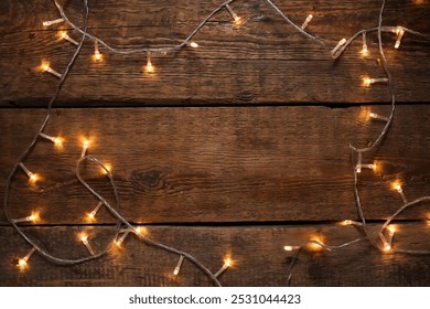 Frame made of glowing Christmas lights on wooden background - Powered by Shutterstock