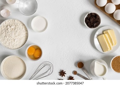 Frame made of ingredients for baking. Ingredients for making dough, cakes, muffins, bread. Baking ingredients: flour, sugar, eggs, spices, milk, chocolate, baking powder
