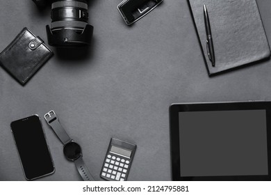 Frame made of modern gadgets, stationery and wallet on dark background - Shutterstock ID 2124795881