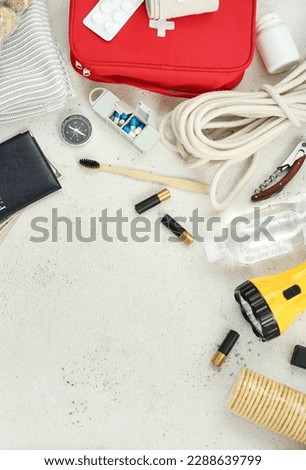 Frame made of necessities for emergency bag on white table Сток-фото © 