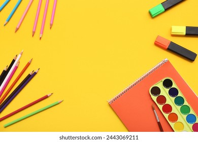 Frame made of notebook, watercolors and stationery on yellow background. Top view - Powered by Shutterstock