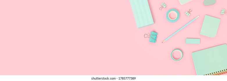 Frame made of school supplies on a pink pastel background. Creative banner with place for text.