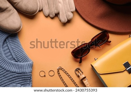 Frame made of stylish female accessories, shoes and clothes on color background