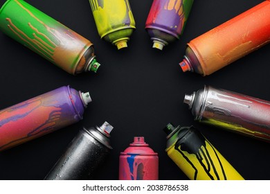 Frame made with used cans of spray paints on black background, flat lay and space for text. Graffiti supplies - Powered by Shutterstock