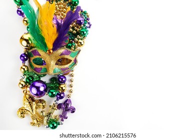 Frame Of Mardi Gras Mask And Beads Isolated On White Background.